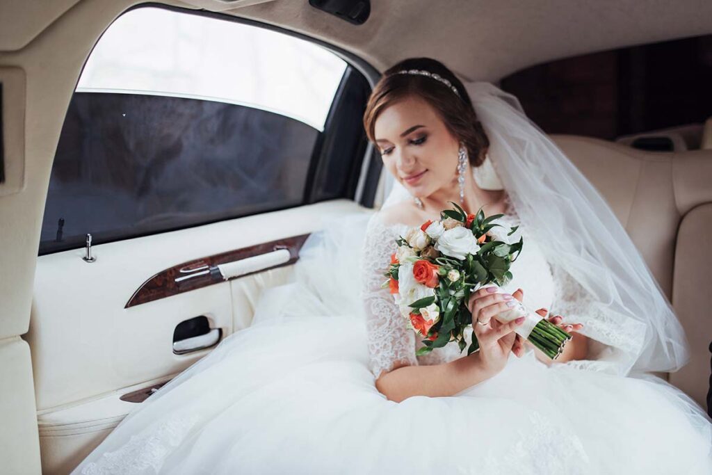 young bride inside a luxury wedding limousine