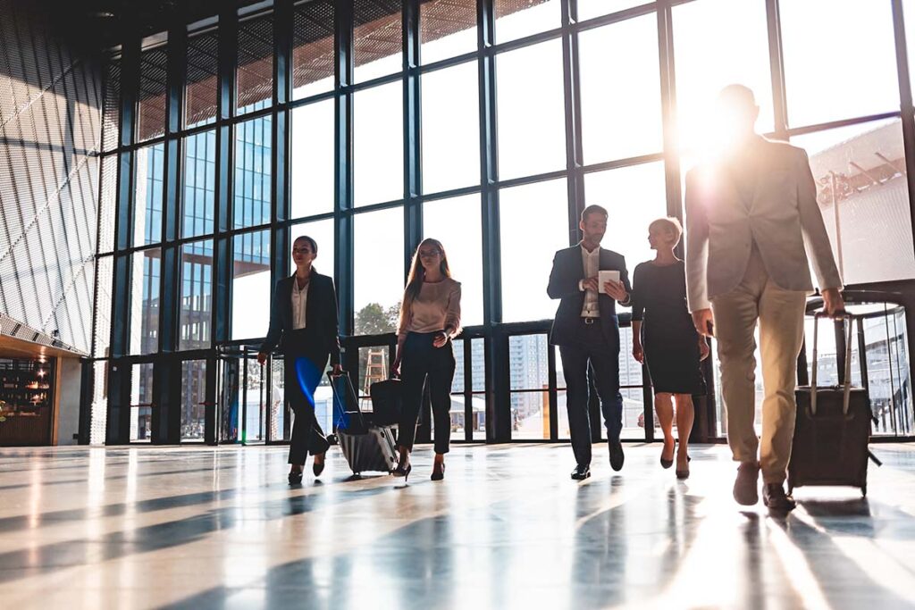 Group of business people walking in airport hall