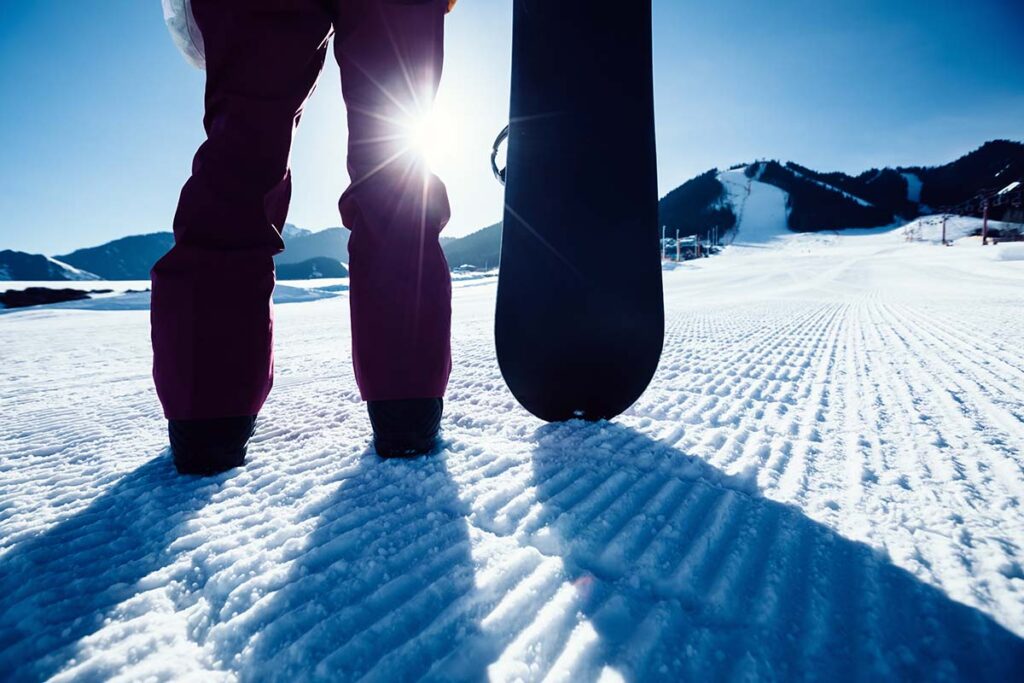 snowboarder with snowboard stand on ski piste in winter mountains in Vail Colorado