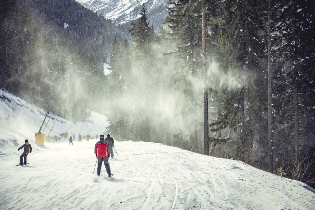 people with ski and snowboards on a ski track in vail co